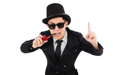 Young detective in black coat holding magnifying glass isolated 