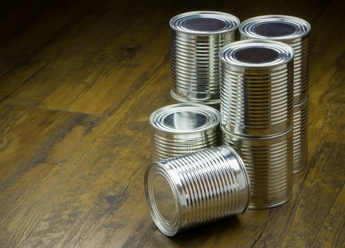 / Tin cans for food on wooden background, Selective focus 