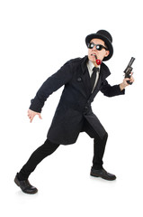 Young detective in black coat holding handgun isolated on white