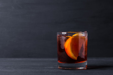 Old fashioned cocktail on the wooden background