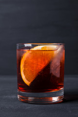 Old fashioned cocktail on the wooden background