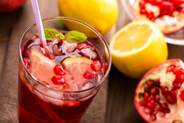 Pomegranate with lemon and ice top view