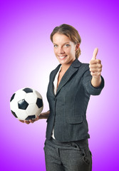 Businesswoman with football on white