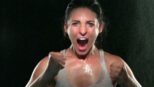 Intense celebration woman athlete intense stare strong powerful eyes determination strength 