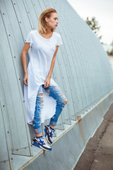 modern punk fashion, portrait of a beautiful model posing over street background