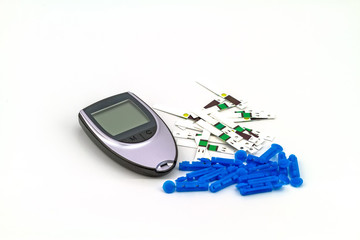 Many strip test of blood glucose meter, the blood sugar value is measured on a finger on white background