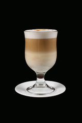 cappuccino in transparent glass on black background