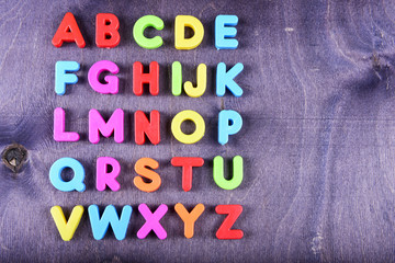 colorful plastic English alphabet on a bright background - 93362927