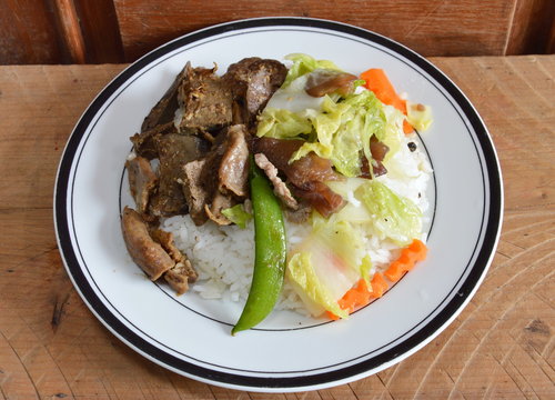 fried pork entrails with garlic and stir-fried mixed vegetable on rice