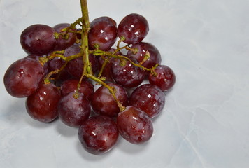 red grape on white tile