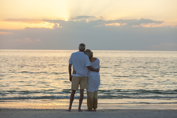 Senior Couple at Sunset Tropical Beach - obrazy, fototapety, plakaty