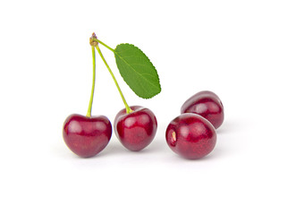 Cherries and leaf on white background