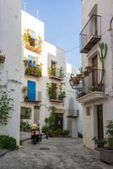 Narrow street with white houses. Mediterranean style Spain