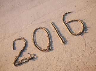 2016 drawn on sand on a sunny beach