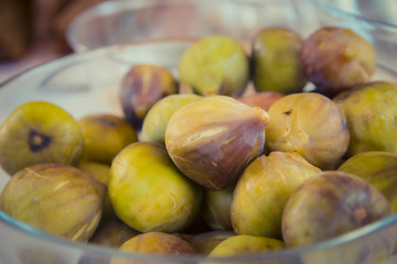 Close up on figs in a glass bowl

