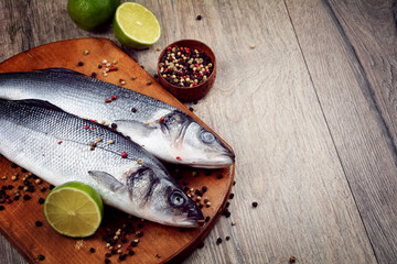Raw seabass fish on the wooden board