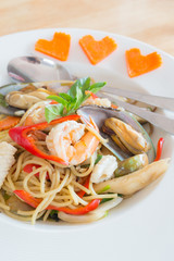 Spicy sea food spaghetti on white dish