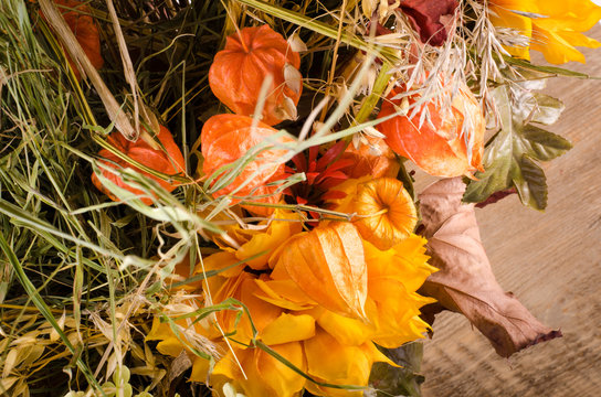 Autumn bouquet. Dried flowers and cape gooseberry on wooden