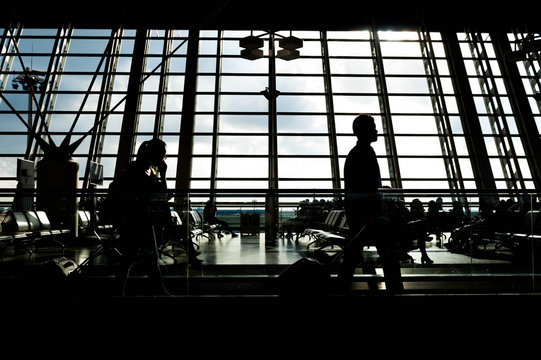 Airport terminal hall. Walking travelers