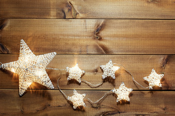 Stars Christmas lights on wooden background