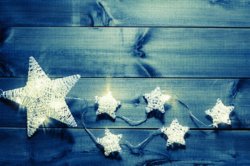 Stars Christmas lights on wooden background