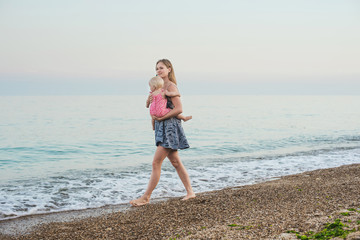 mother and daughter having fun on beach