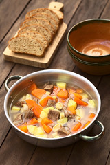 Traditional Hungarian soup called Gulyasleves (Goulash soup) made of beef, potato, carrot, onion, csipetke (homemade pasta) (Selective Focus, Focus one third into the soup)