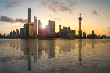Shanghai, China city skyline on the Huangpu River at sunrise with reflection
