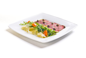 Carpaccio with parmesan cheese, arugula and capers
