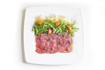 Carpaccio with parmesan cheese, arugula and capers