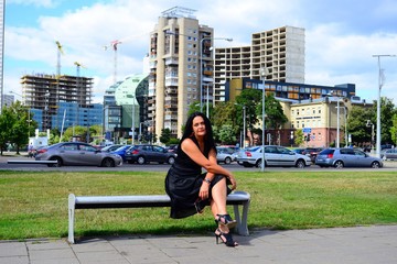 Vilnius city woman in black and skyscrapers view