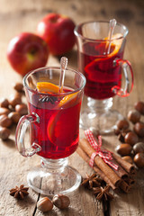 glass of mulled wine with orange and spices, winter drink