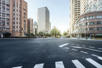 Fotobehang empty asphalt road of a modern city with skyscrapers © zhu difeng