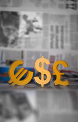 World currency units front of newspaper's economy pages