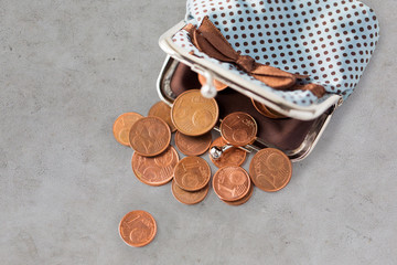 close up of euro coins and wallet on table