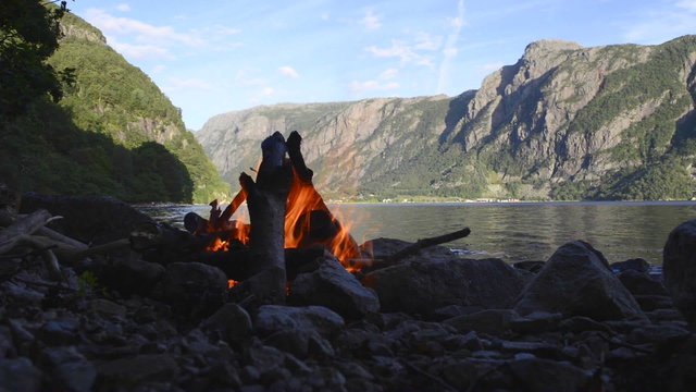 Campfire on the shore of a Fjord in Norway during summer