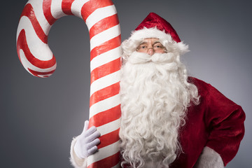 Giant candy cane held by the santa claus