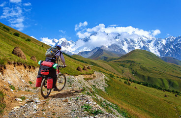 Fototapeta premium Cyclist riding on mountain serpentine in Georgia