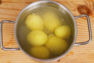 pot with peeled potatoes