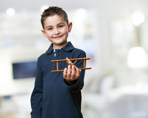 little kid playing with a biplane