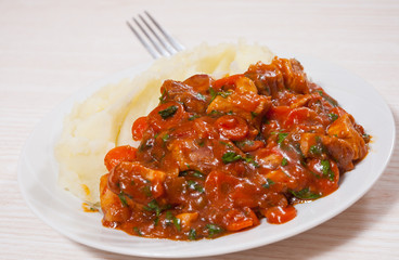 meat in sauce with mashed potatoes