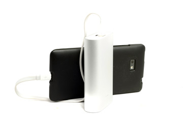 dusty mobile phone and an external battery on a white background