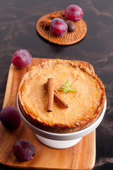 Plum pie, spices and plums decorated with mint and cinnamon on a