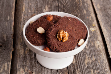 chocolate cookies,nuts and spices on wooden table