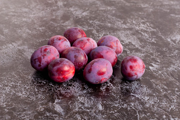 Fresh Plums on black Table