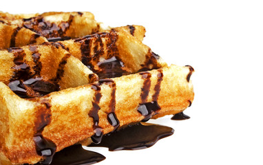 Freshly baked belgium waffles with chocolate on white background