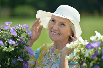 Fototapeta premium Older woman with flowers