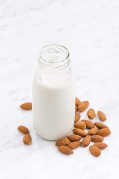 almond milk in a glass bottle, vertical, top view
