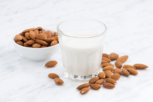 almond milk in a glass on white table