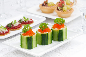cucumber tartlets with cream cheese and red caviar for holiday
